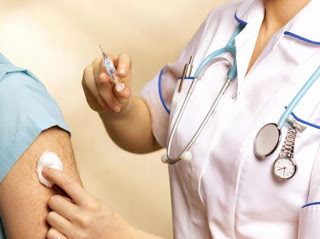 A healthcare provider preparing to vaccinate someone's arm
