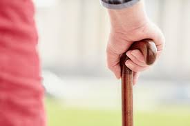 Closeup of a hand on a walking cane